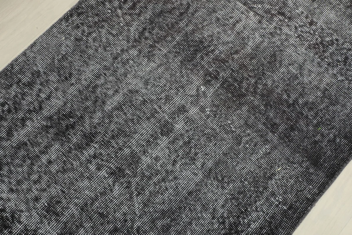 Detailed view of the rug's surface, showing the low pile and intricate hand-knotted construction.