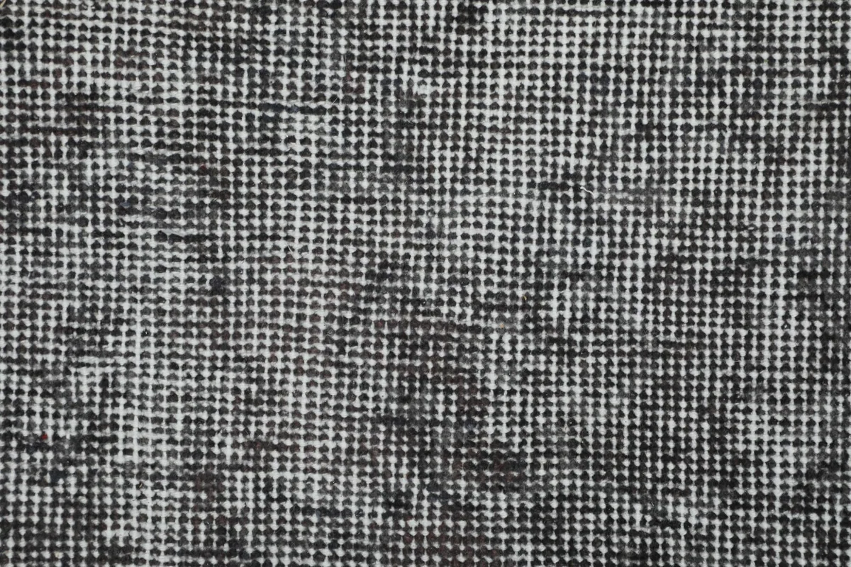 Close-up of the wool pile, showcasing the hand-knotted texture and tight weave of the vintage rug.