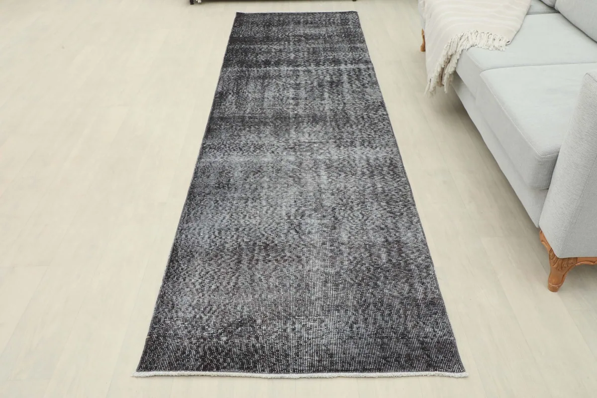 Full overhead view of the charcoal and gray vintage runner rug laid out in a room setting.