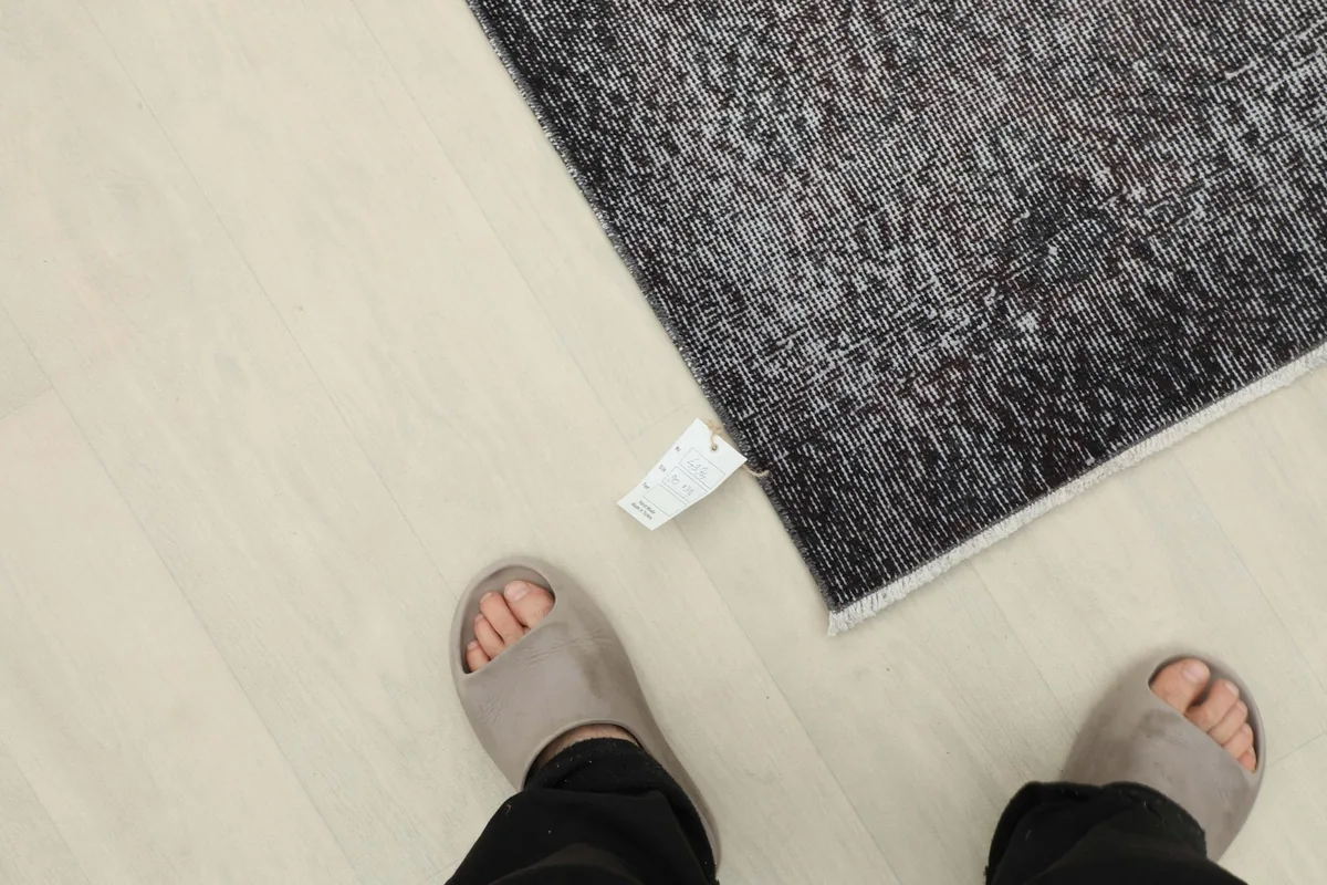 Overhead perspective of a person's feet near the rug, providing a sense of scale for the runner.