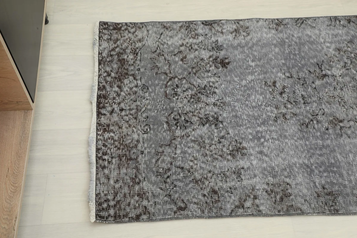 Overhead shot of the runner rug, highlighting the faded floral and geometric motifs