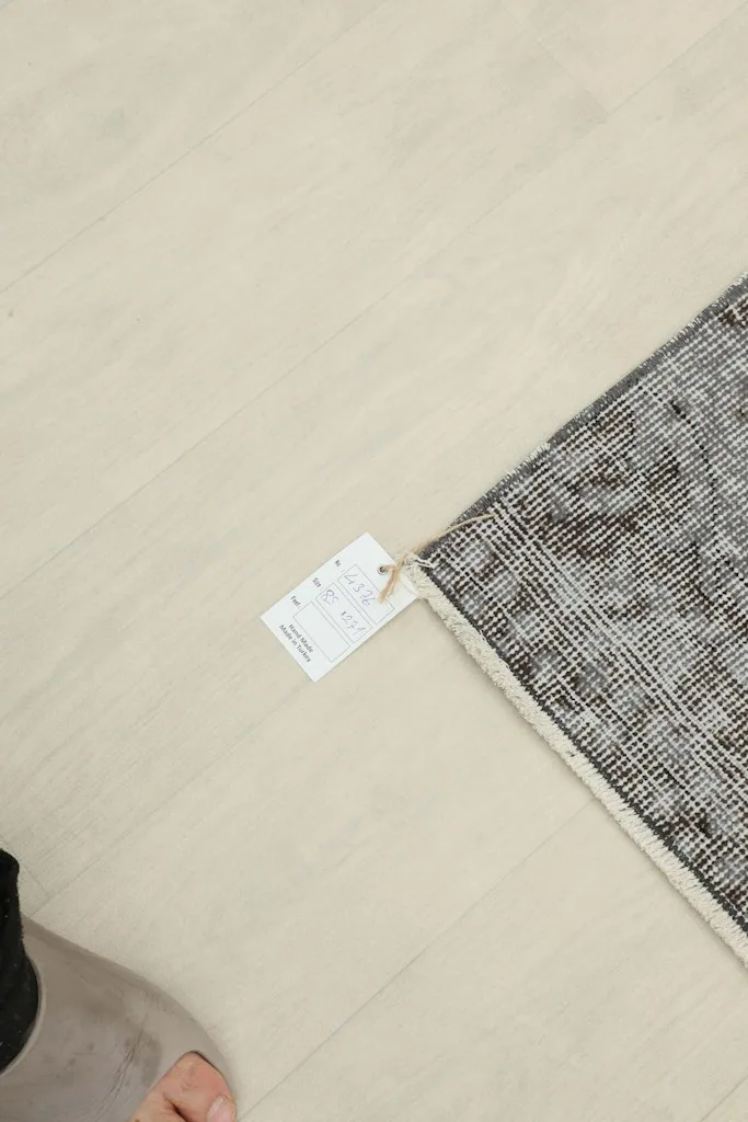 Corner of the rug with a product tag attached, showing the back of the rug