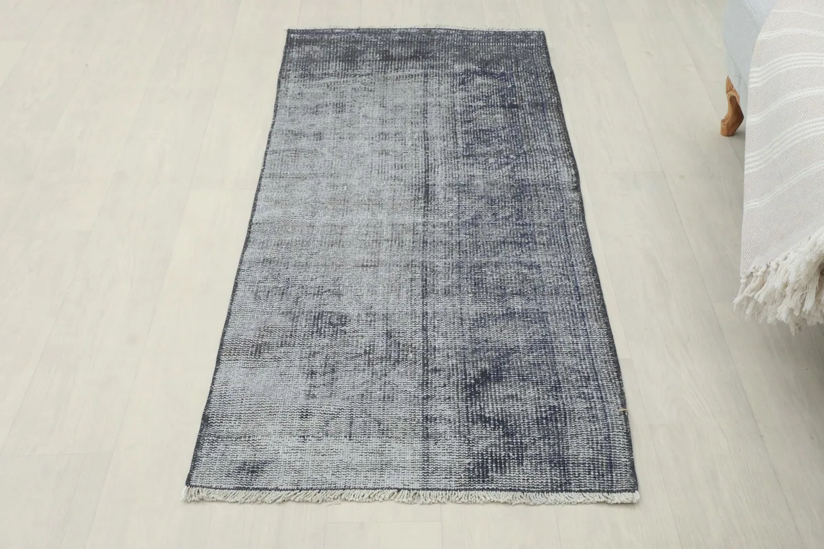 Full view of the charcoal gray runner in a room, offering a complete perspective of its placement and size.