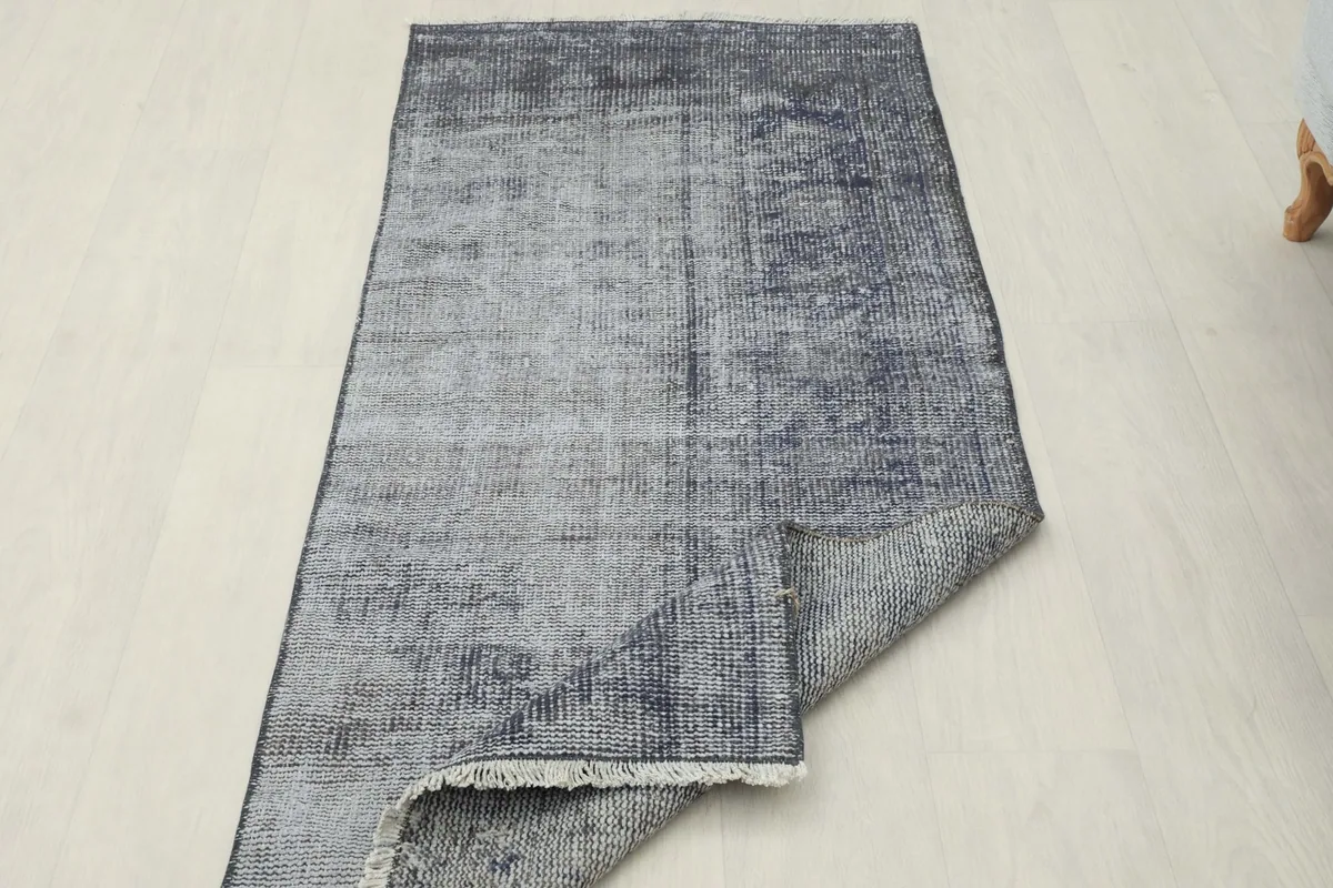 View of the runner with one corner lifted, revealing the cotton foundation on the back.