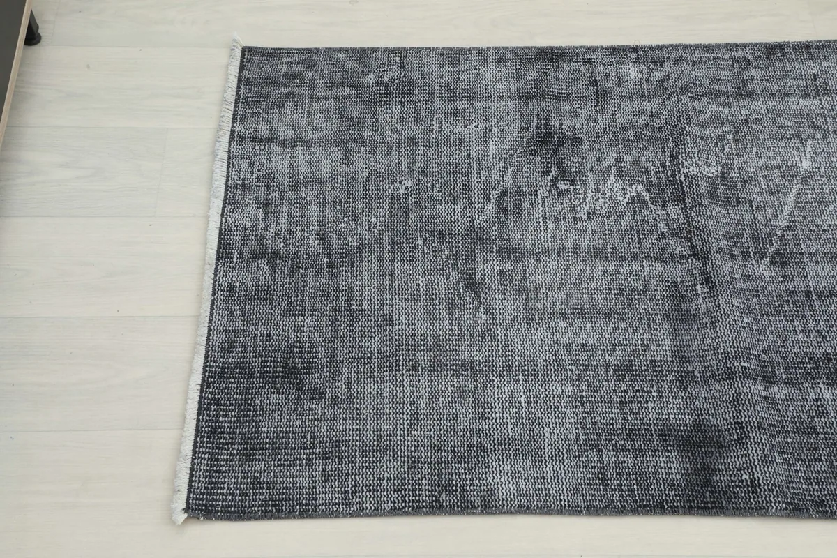 Angled view of the other end of the runner, highlighting the faded gray and charcoal colors.