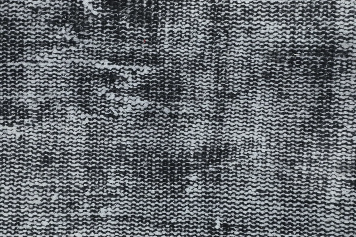 Close-up of the low wool pile and hand-knotted texture, revealing the cotton foundation beneath.