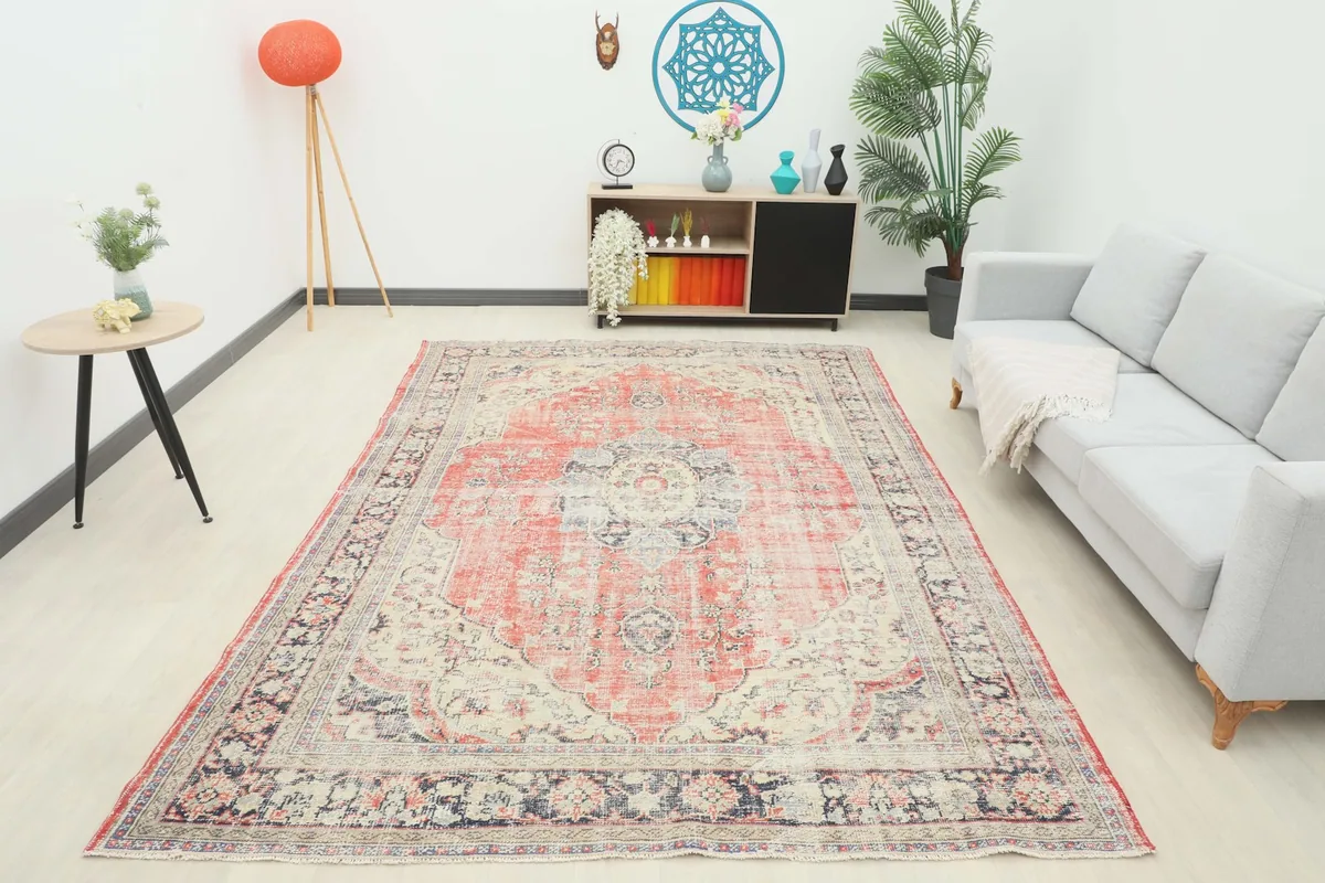 Full room view of the large vintage red and cream area rug, anchoring the living space.