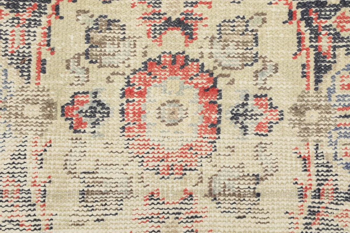 Detailed view of the low wool pile, showing the texture and the subtle wear of the vintage rug.