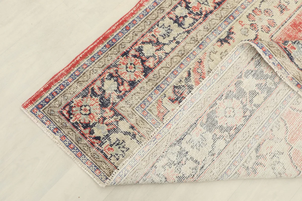 Underside view of the hand-knotted wool pile on cotton foundation, showing rug construction.