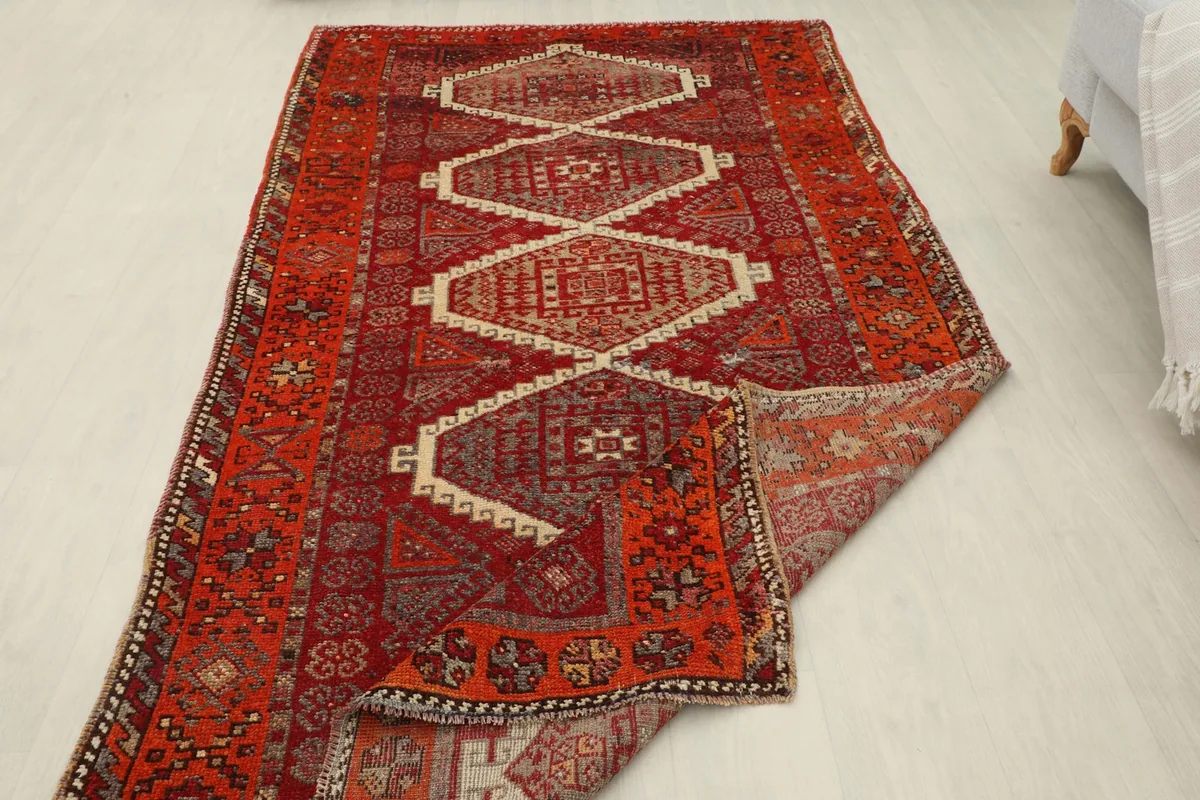 View of the rug with one corner folded back, showing the cotton foundation