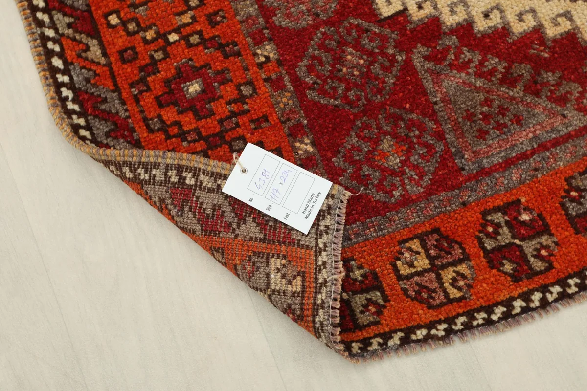 Folded corner of the rug with product tag visible, showing details of the weave