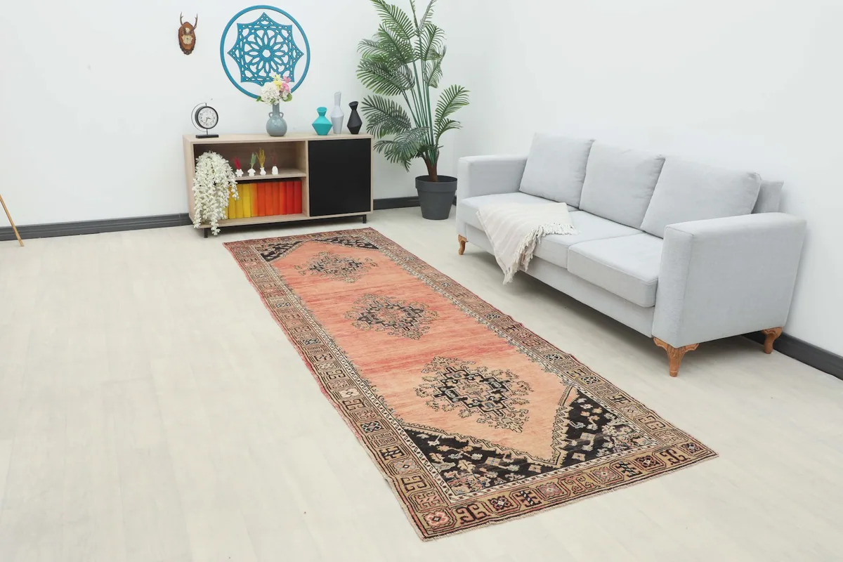 Rose runner rug in a modern hallway setting with a light gray sofa and shelving