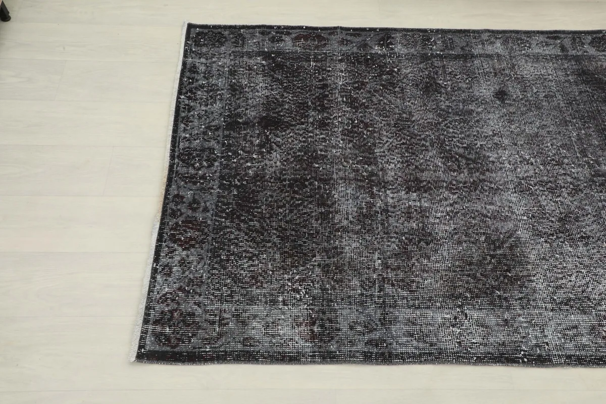Close-up angled view of the bottom right corner of the rug, detailing the border design.