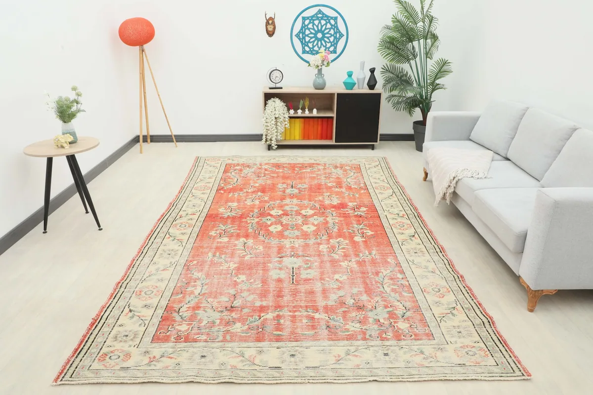 Full room view of the rust floral rug, showcasing its vibrant presence and large size in a living space