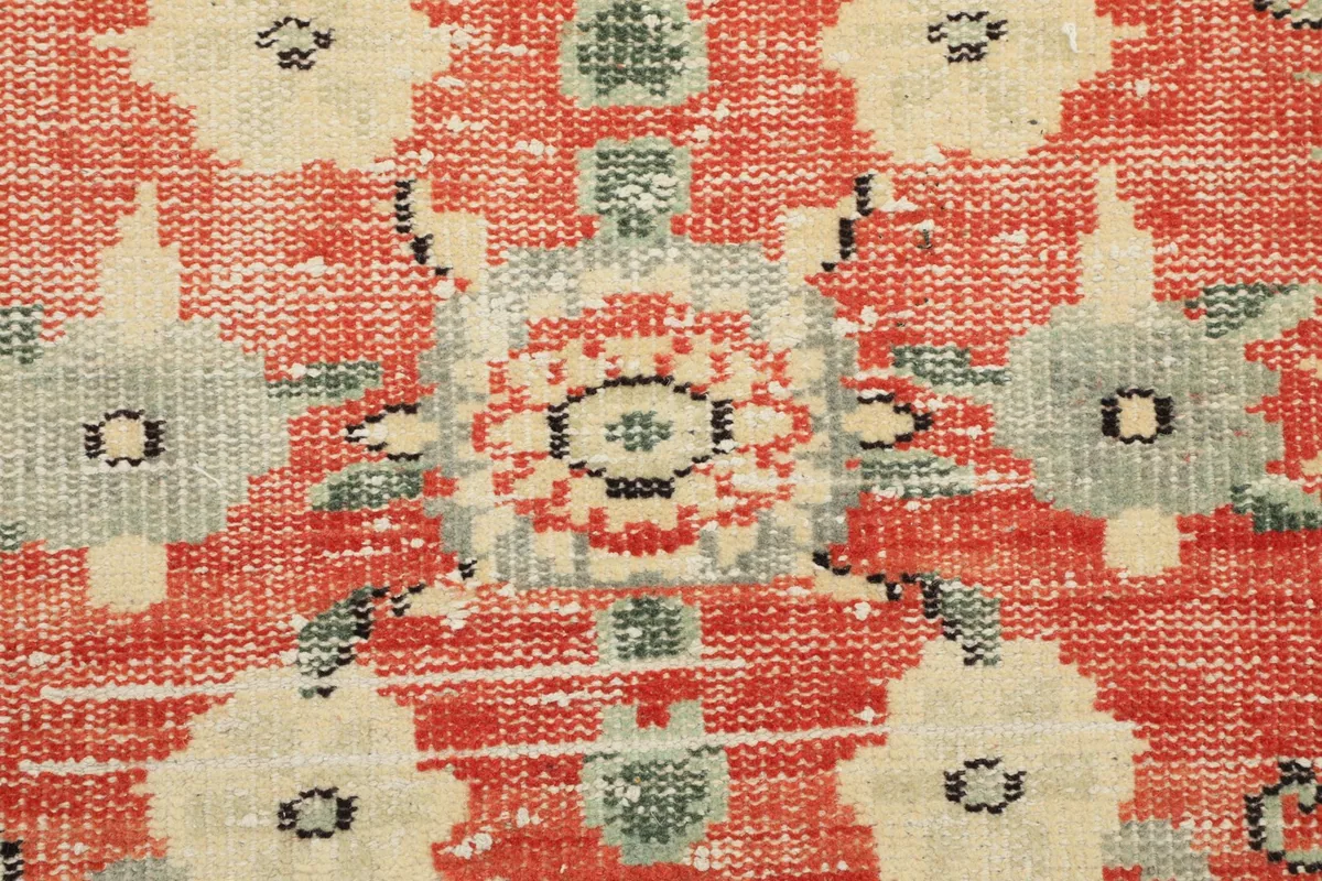 Extreme close-up of the hand-knotted wool pile, showing individual knots and color blending
