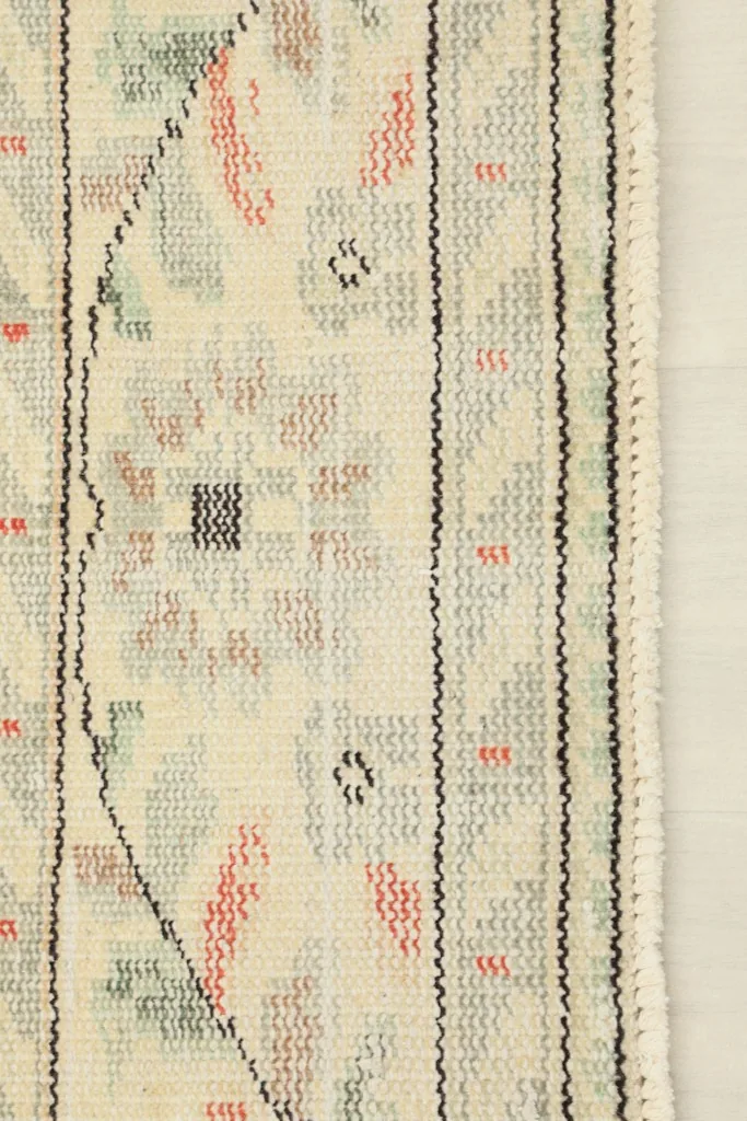 View of the back of the rug, revealing the cotton foundation and hand-knotted construction