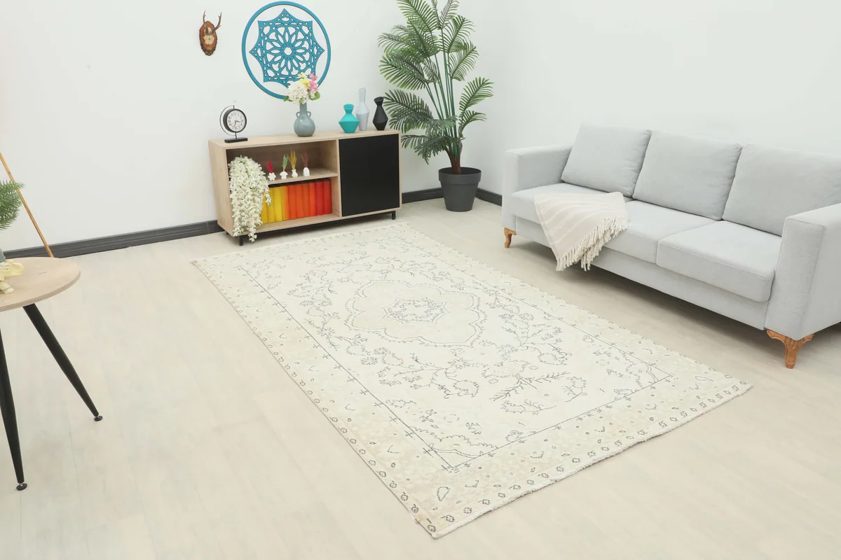 Ivory Medallion Anatolian Rug in a living room setting, viewed from an angle.