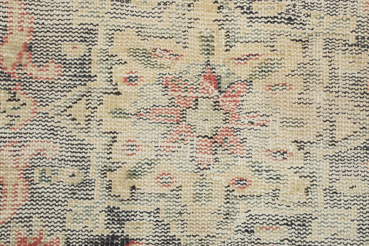 Close-up of the hand-knotted wool pile, revealing the low pile and intricate knotting structure.