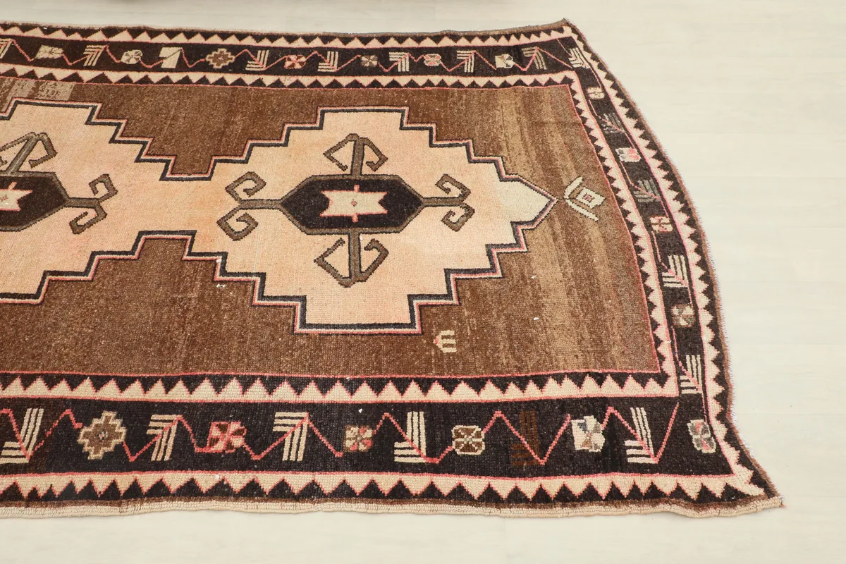 Close-up view of the corner of the Beige Brown Tribal Anatolian Rug, highlighting border details.