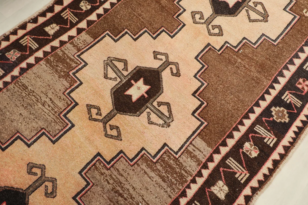 Angled close-up of the central beige geometric medallion on the Beige Brown Tribal Anatolian Rug.