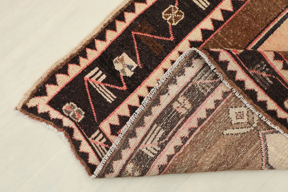 Beige Brown Tribal Anatolian Rug folded to show the back and weave structure.
