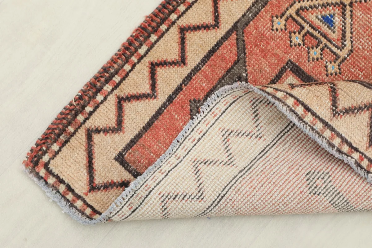 View showing the reverse side of the hand-knotted wool rug, revealing its cotton foundation