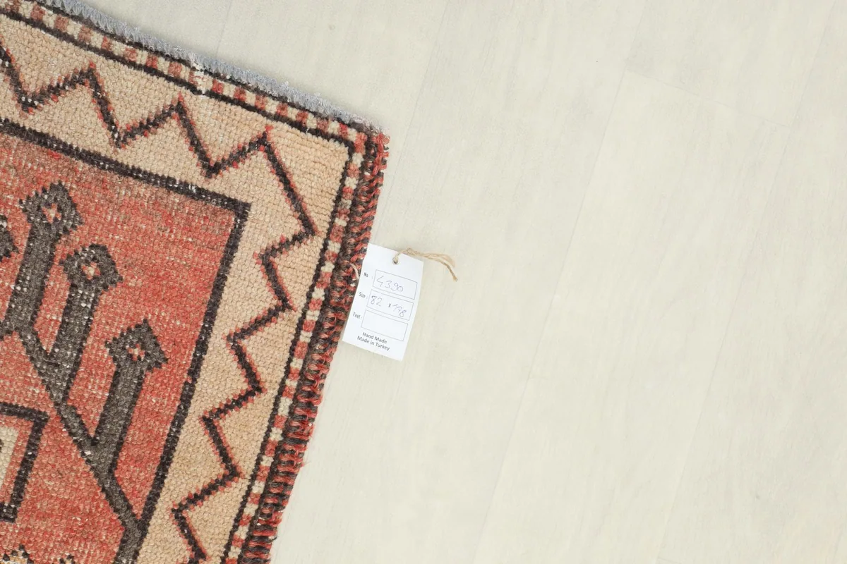 Corner of the rug with a product tag, indicating its origin and quality