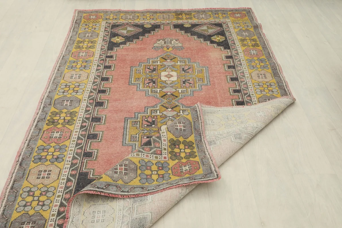 The rug partially folded to display its flexibility and the quality of the wool and cotton materials.