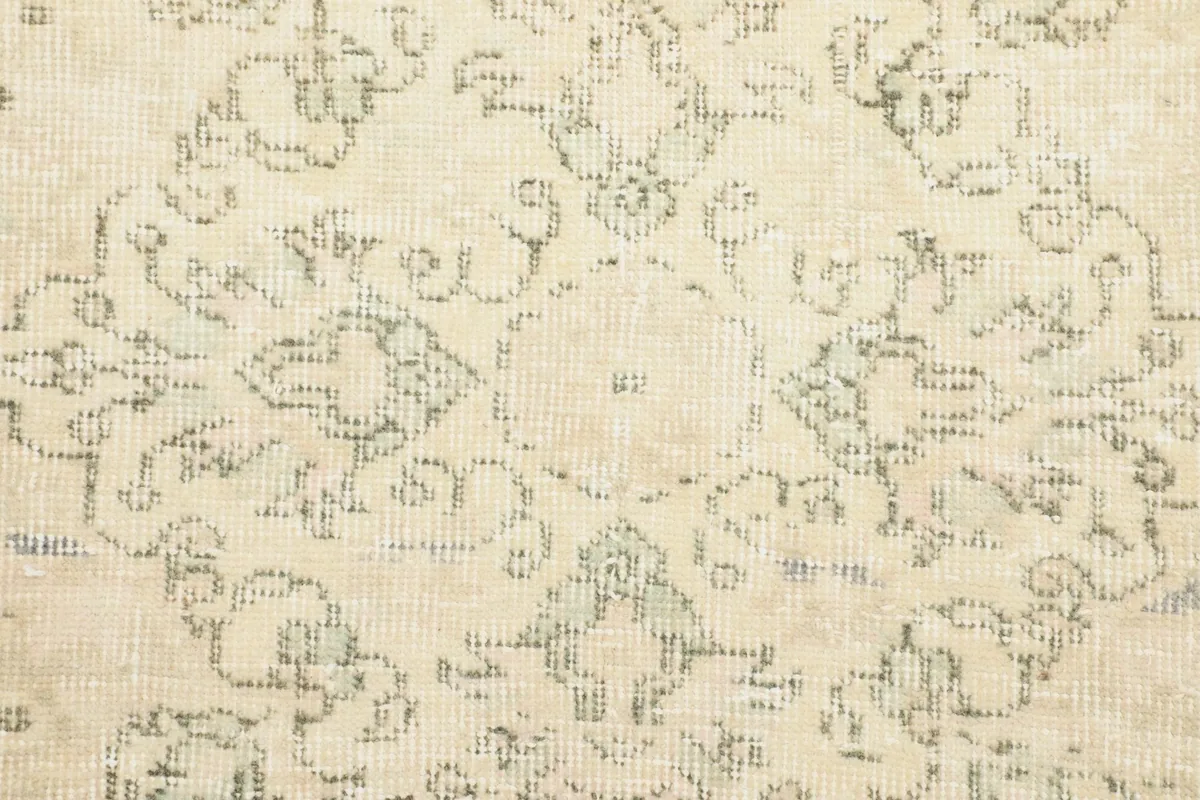 Close-up of the central medallion, revealing the intricate geometric motifs and gentle wear.