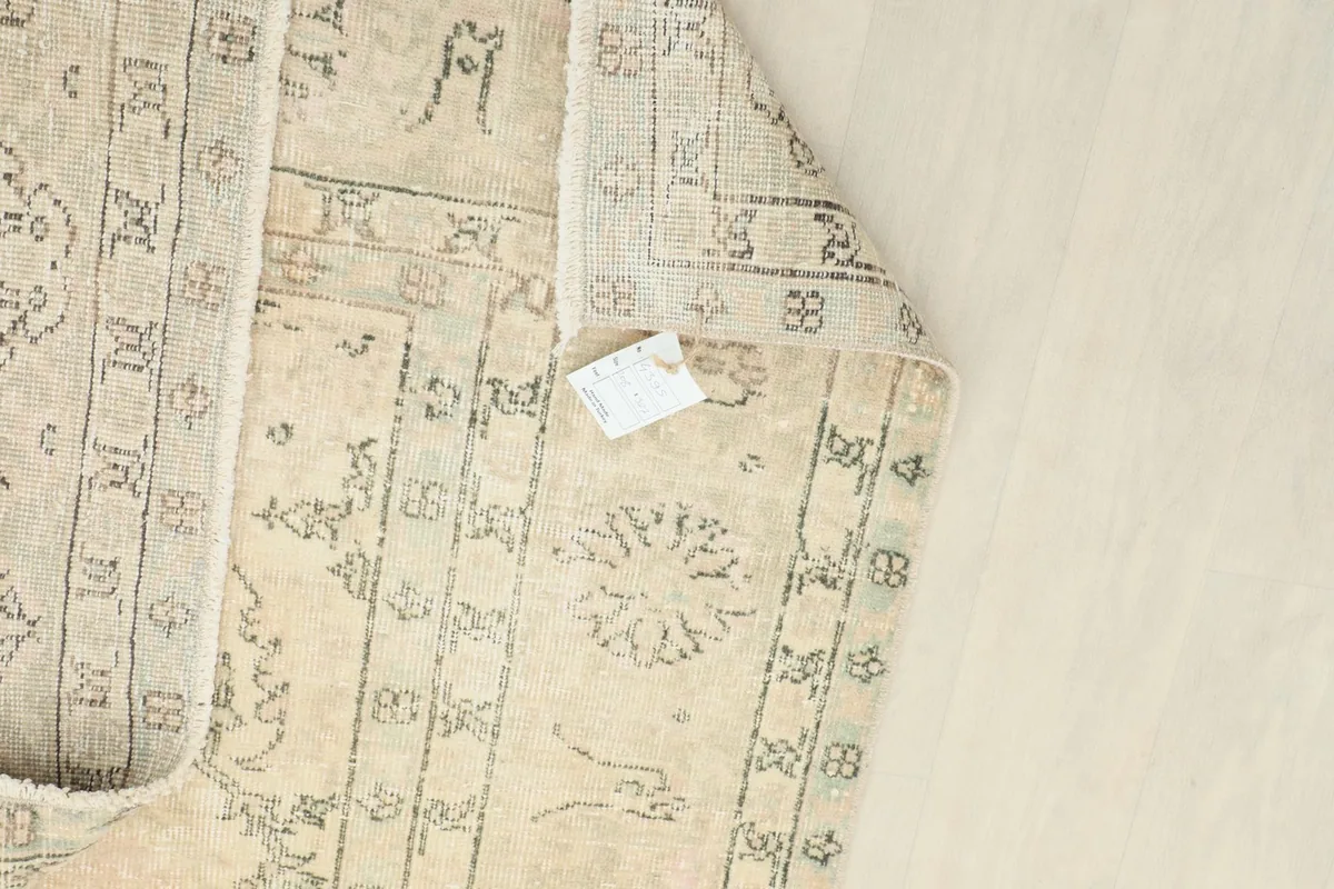 View of the back of the rug, revealing the consistent hand-knotting and overall structure.