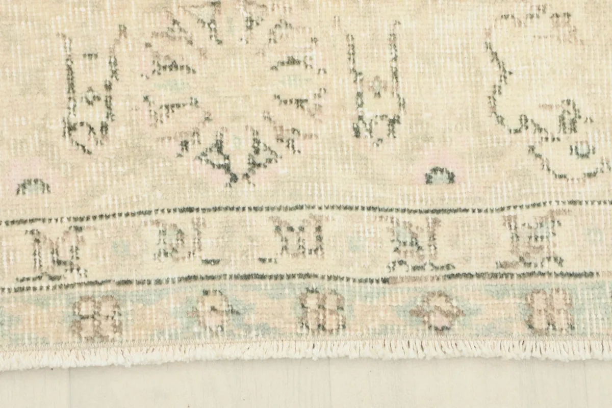 Close-up of the rug's edge and fringe, showing the hand-knotted construction and cotton foundation.