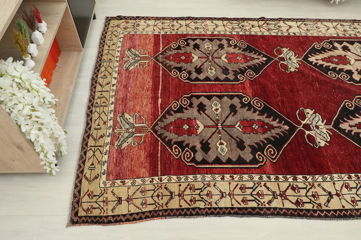 Another angle view showing the rug's design and color variations on the red field