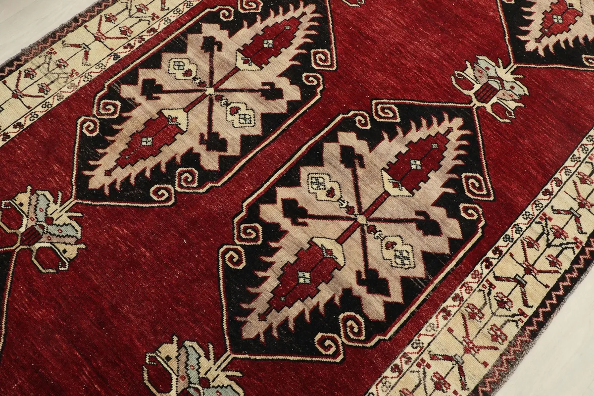 Detailed view of the central geometric motifs in black, cream, and red tones
