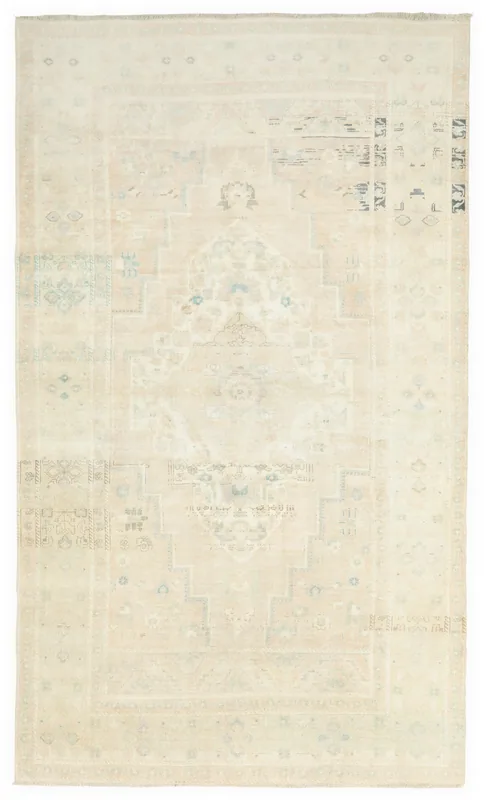 Full overhead view of a vintage ivory and beige Anatolian area rug with a central medallion
