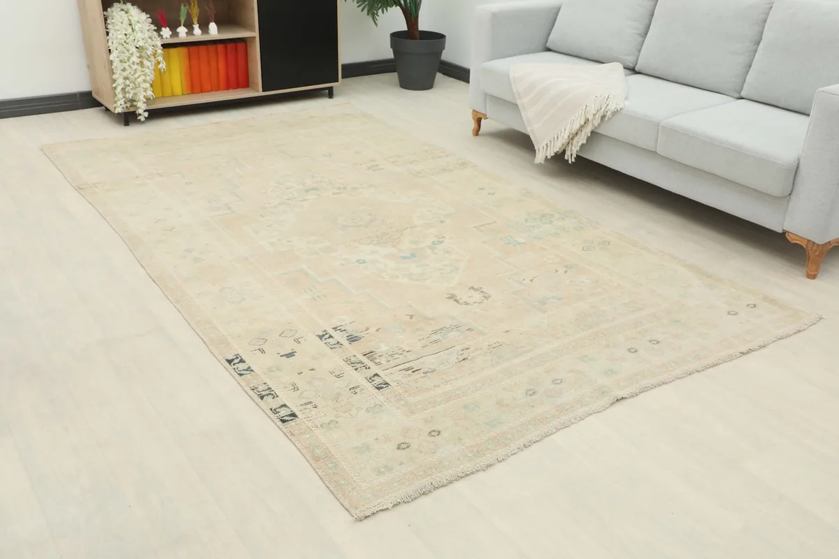 Angle view of the rug in a living room, highlighting its neutral tones and large size