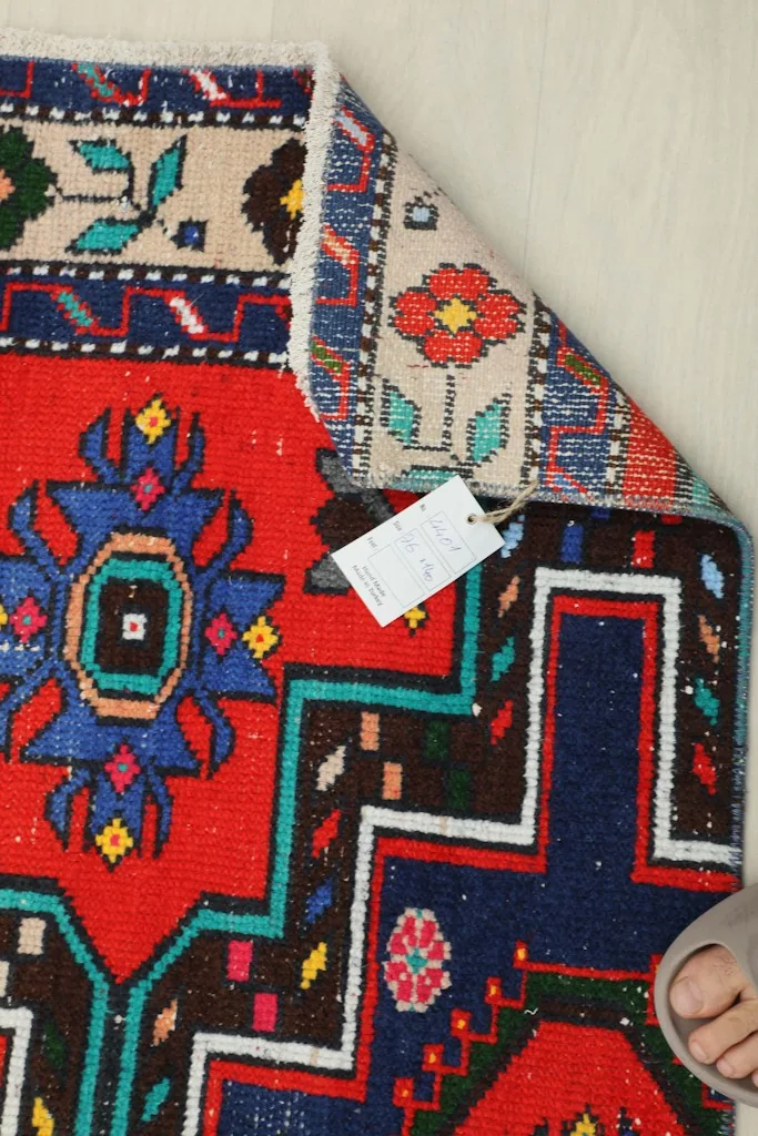 Underside of the rug with a tag, showing the hand-knotted cotton foundation