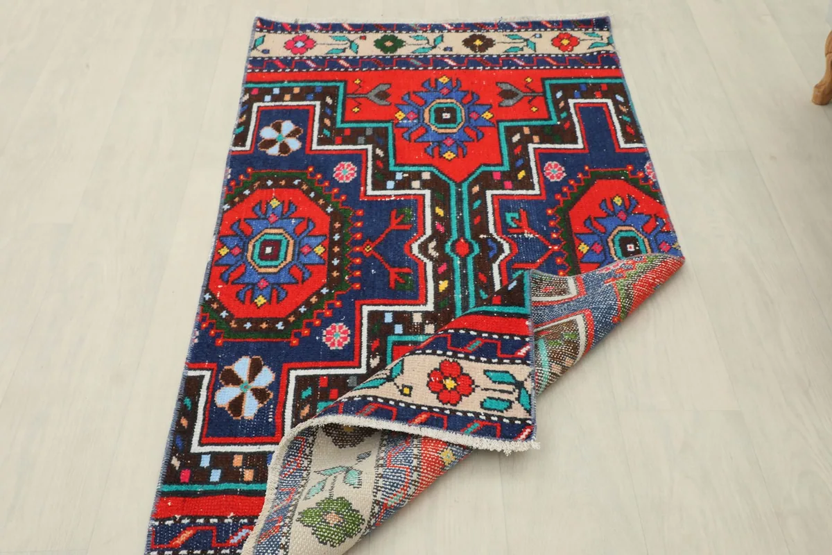 Rug with one corner folded back, showing the full design and construction