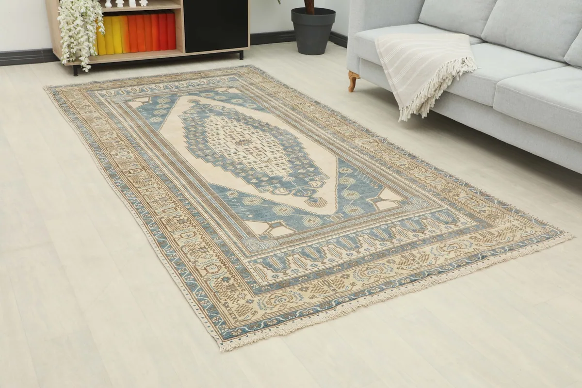 Another angle view of the 5x10 blue and beige geometric rug in a modern living space.