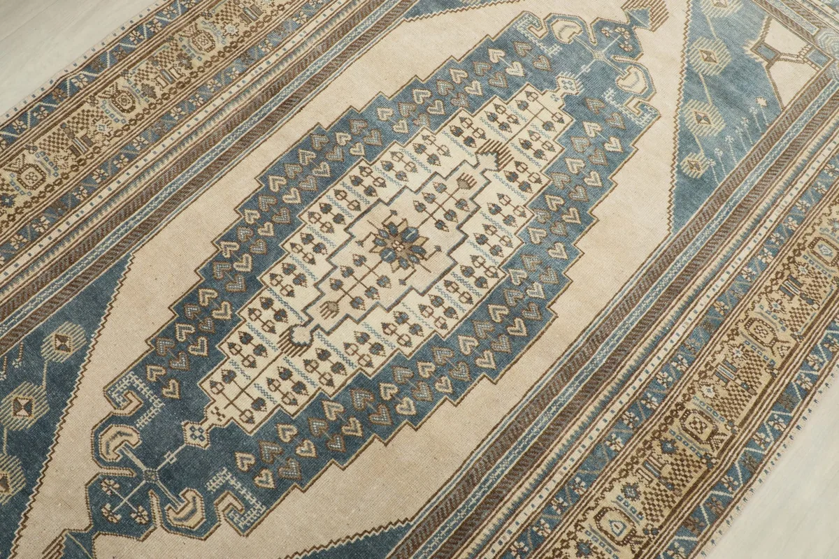 Detailed view of the central blue and beige medallion with intricate geometric motifs.