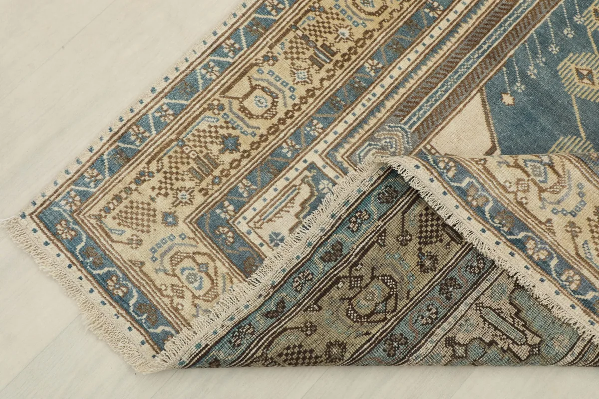 View showing the reverse side of the hand-knotted wool rug, revealing its cotton foundation.