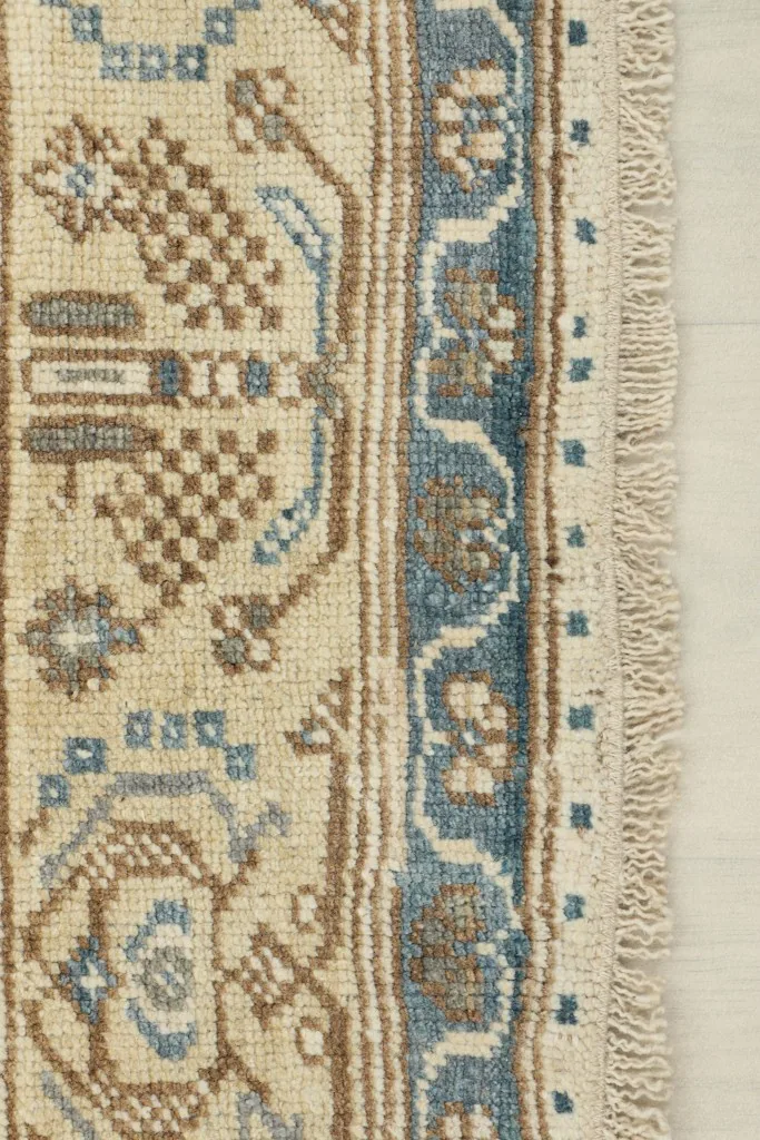 Close-up of the rug's short fringe and the edge of the border design.