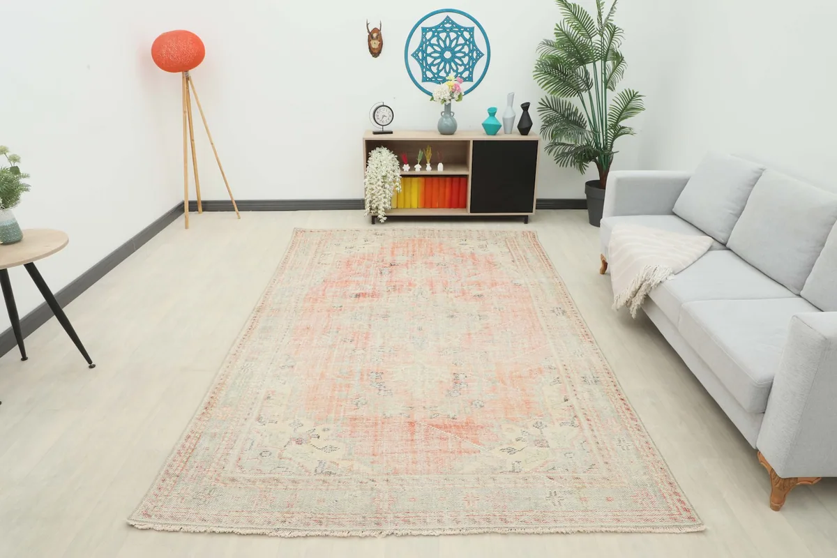 Full room view of the large rose geometric Anatolian rug, providing context for its size and aesthetic