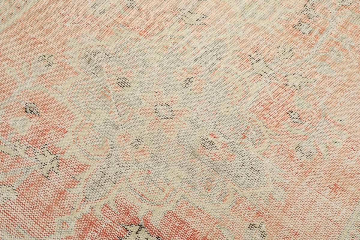 Macro view of the hand-knotted wool pile, showing the intricate geometric motifs and color variations