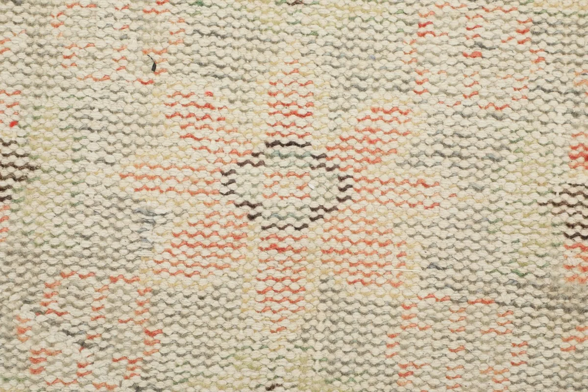 Close-up of the low pile texture and individual wool knots, revealing the rug's construction