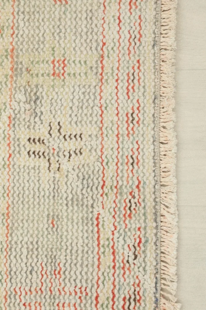 View of the rug's reverse side, showing the cotton foundation and fine hand-knotting craftsmanship