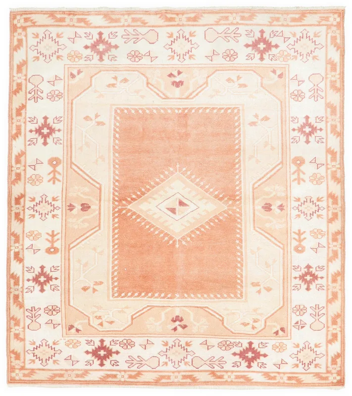 Full overhead view of the orange and cream vintage Anatolian rug with geometric patterns