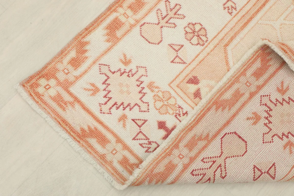 Folded corner of the rug, revealing the density of the wool pile and knotting
