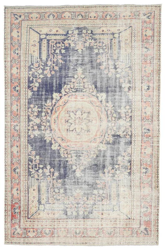 Full overhead view of the navy and rose Anatolian vintage area rug on a white background.