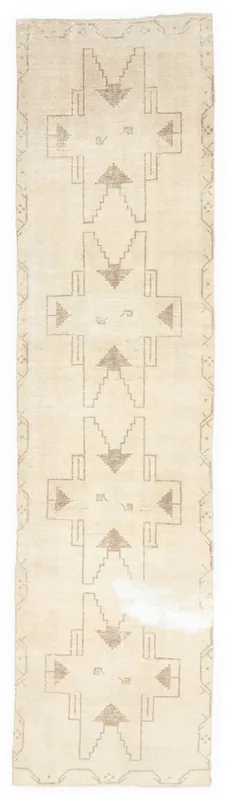 Full top view of the 3'3" x 12'10" ivory and tan geometric Anatolian runner rug