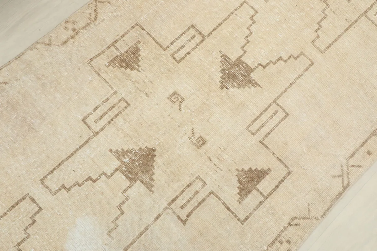 Close-up of the central geometric patterns and subtle color variations in the pile